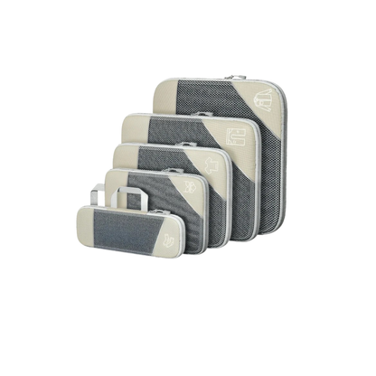 Set of gray and beige travel packing cubes on a white background