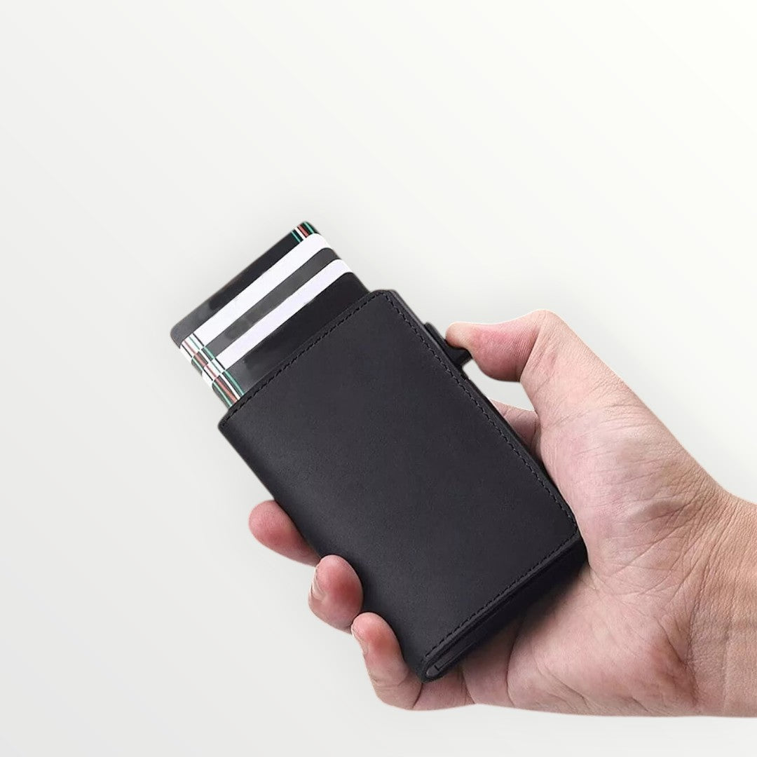 Hand holding a black wallet with striped cards on a white background